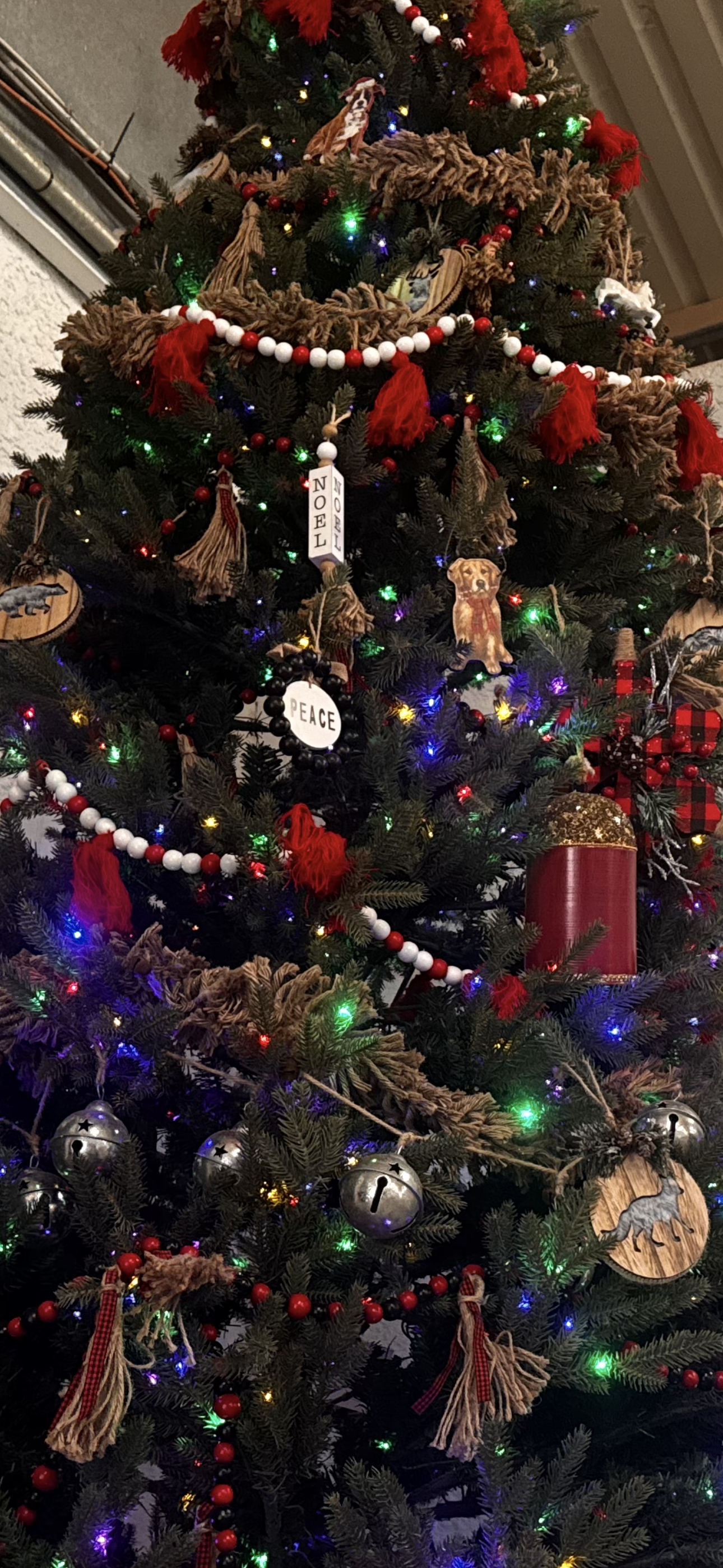 Beautifully decorated Christmas tree at Windrock Farm with rustic ornaments and colorful lights