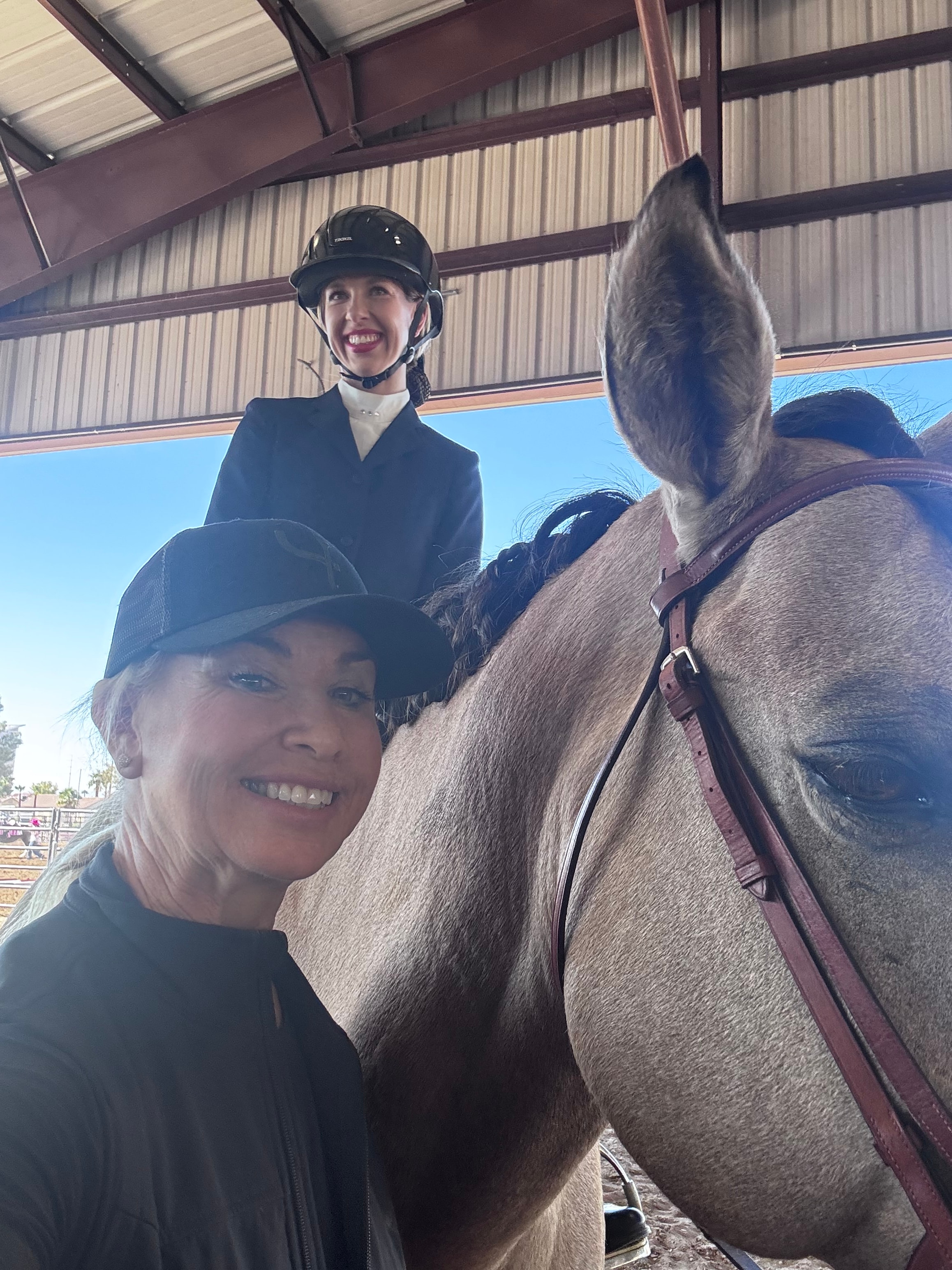Two riders with a grey horse at a Las Vegas horse show