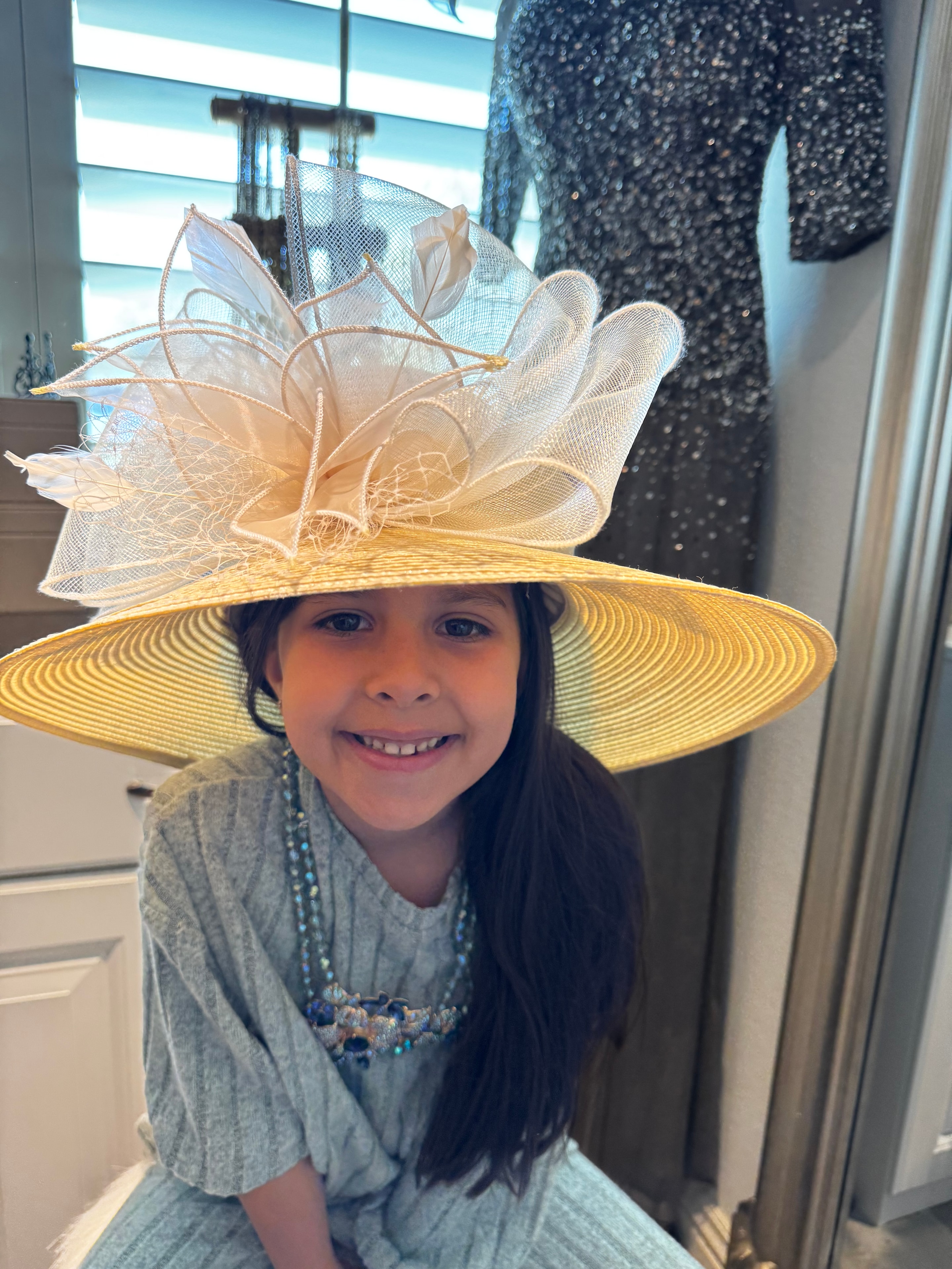 Young girl wearing a large elegant yellow hat at Windrock Farm Big Hat Party Kentucky Derby celebration