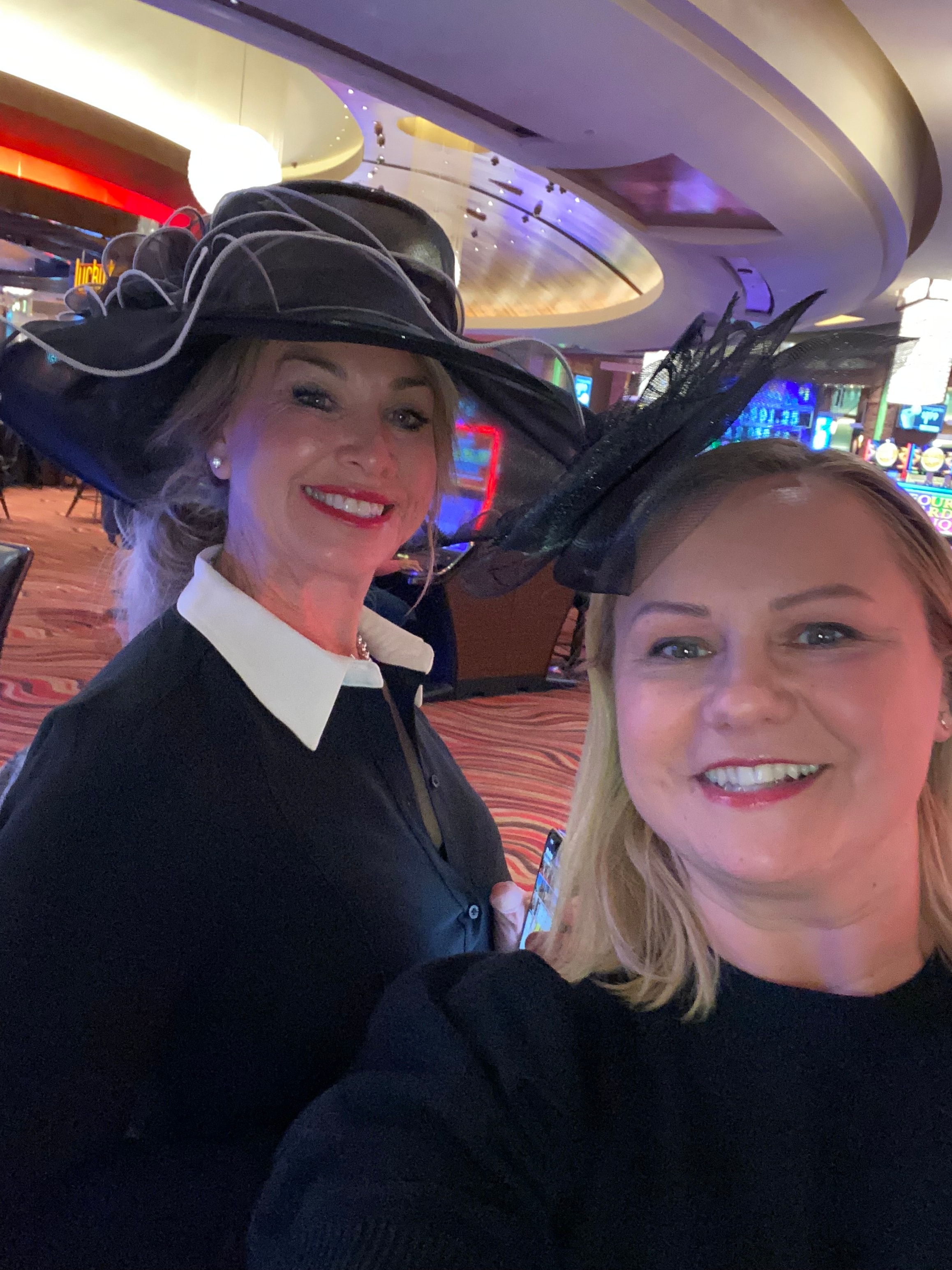 Two women wearing elegant hats at Windrock Farm Big Hat Party Kentucky Derby celebration