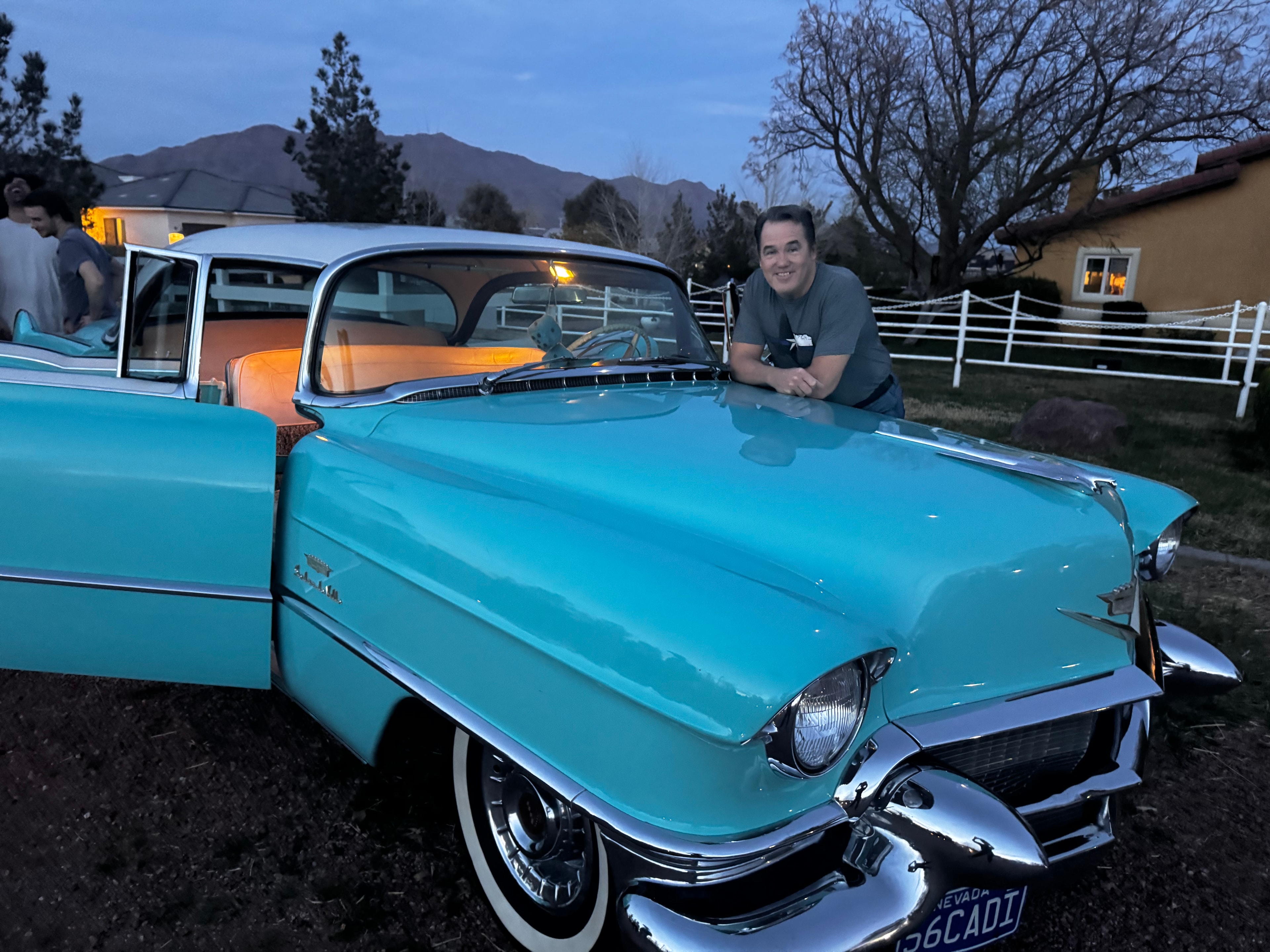 Man posing with a classic turquoise Cadillac at Windrock Farm special event