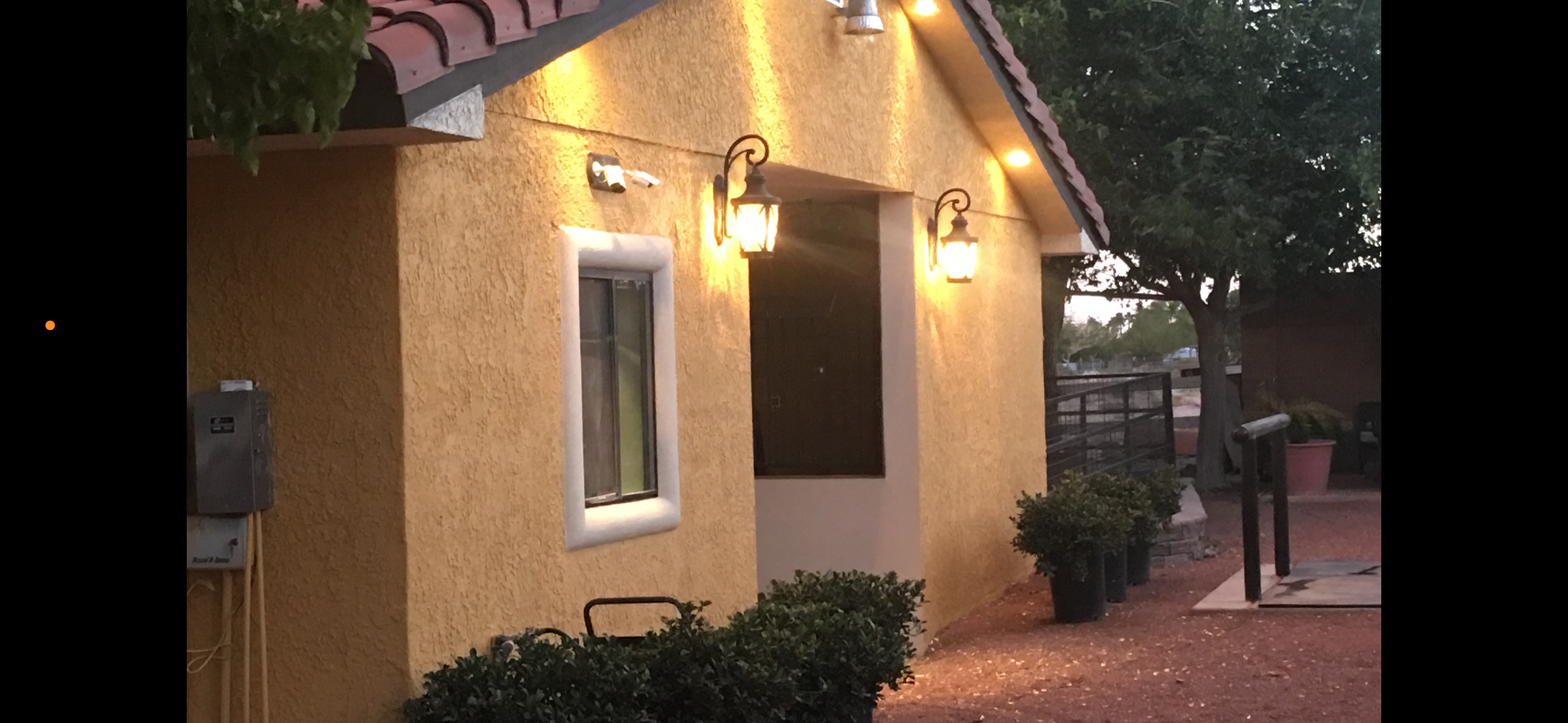 The Show Barn at Windrock Farm lit up at dusk with warm lantern lights